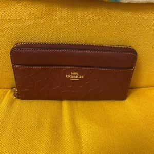 Burgandy wallet, missing wrist strap